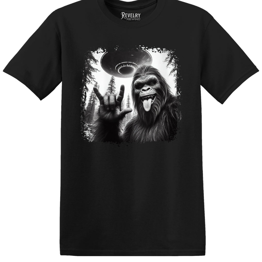 Flat lay of Bigfoot UFO Rocker design on black t-shirt
