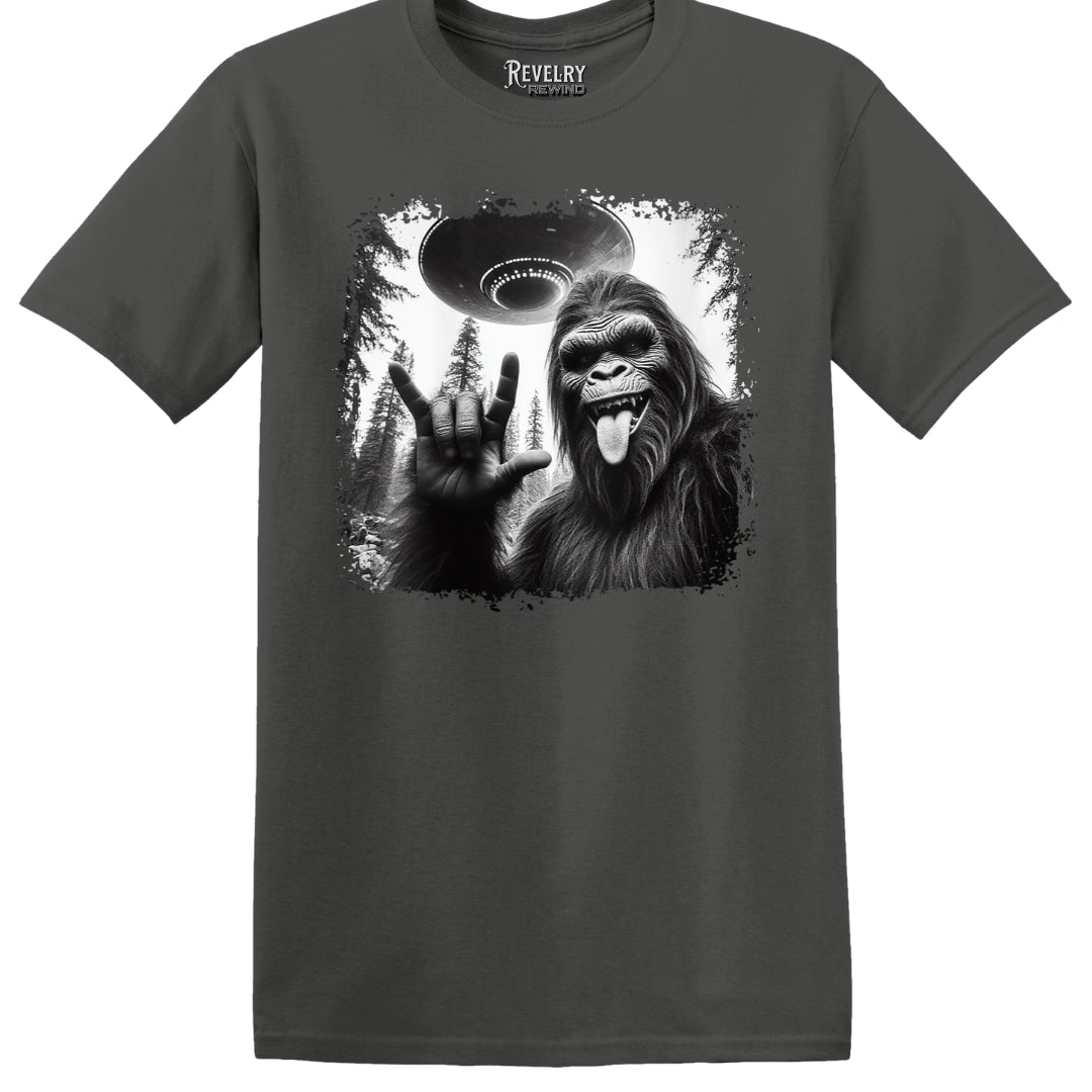 Flat lay of Bigfoot UFO Rocker design on charcoal t-shirt