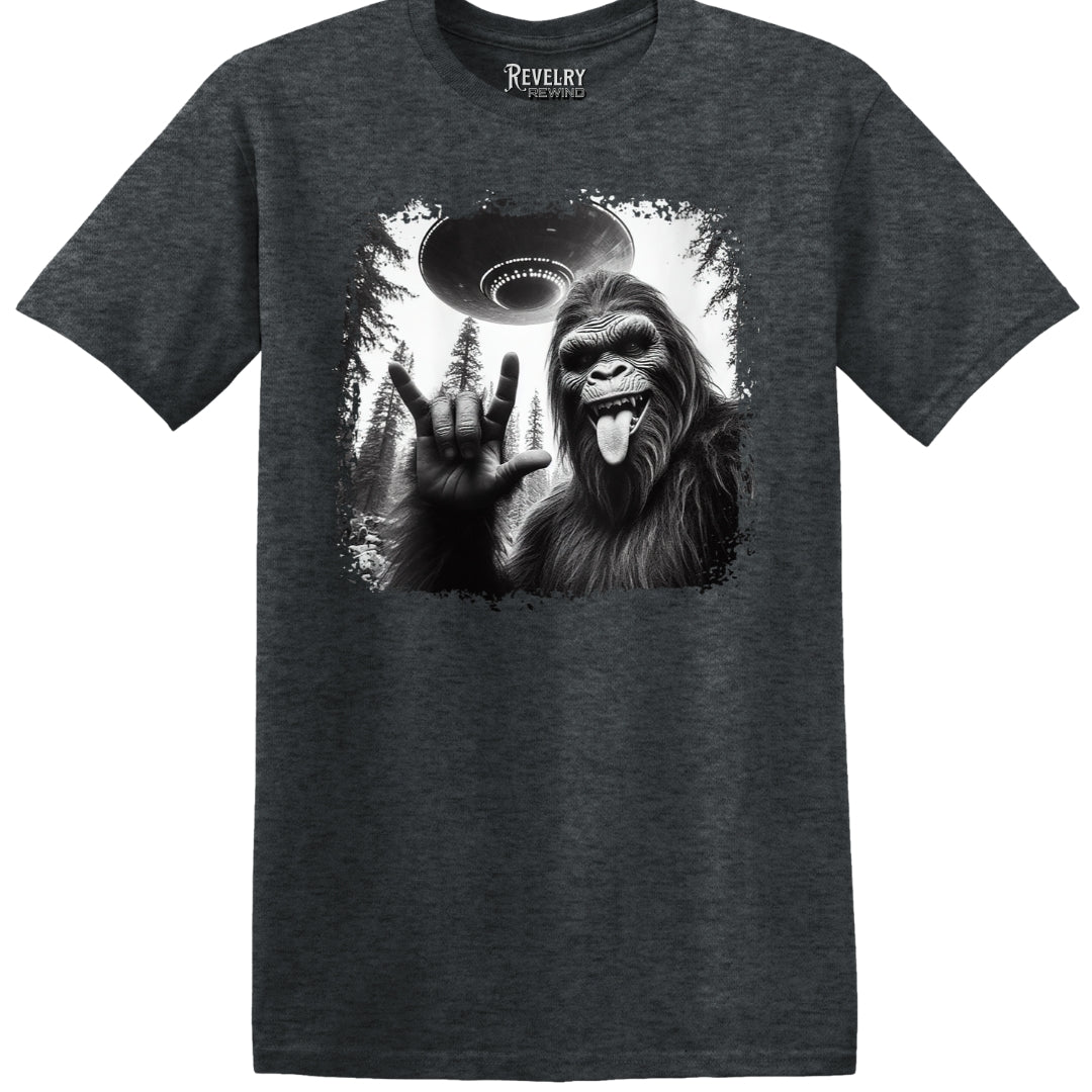 Flat lay of Bigfoot UFO Rocker design on dark heather t-shirt
