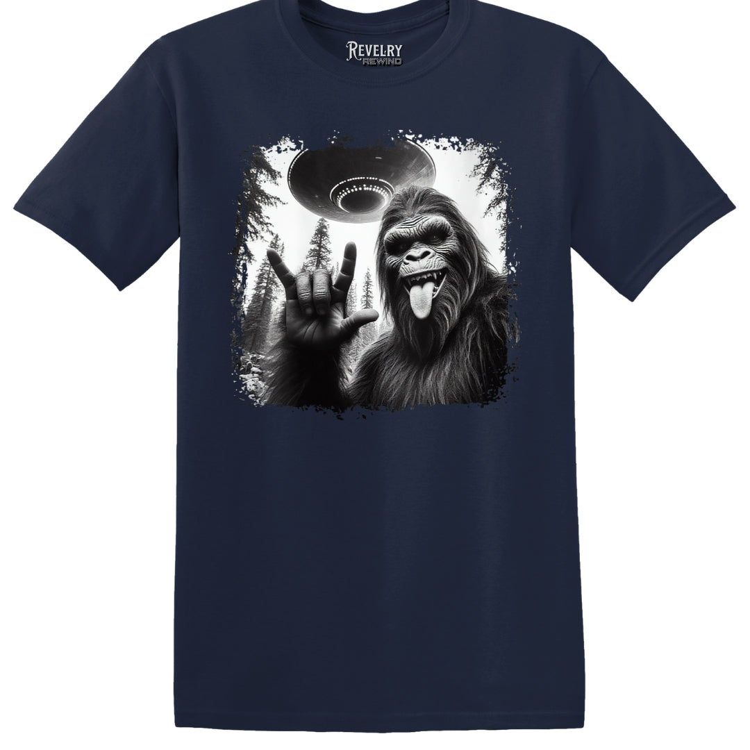 Flat lay of Bigfoot UFO Rocker design on navy t-shirt