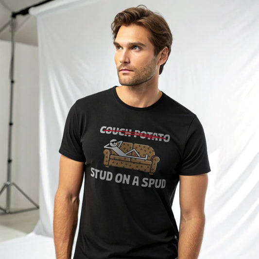 Male model wearing a black crew-neck t-shirt with “Couch Potato: Stud on a Spud” graphic, studio shot on white drape background.