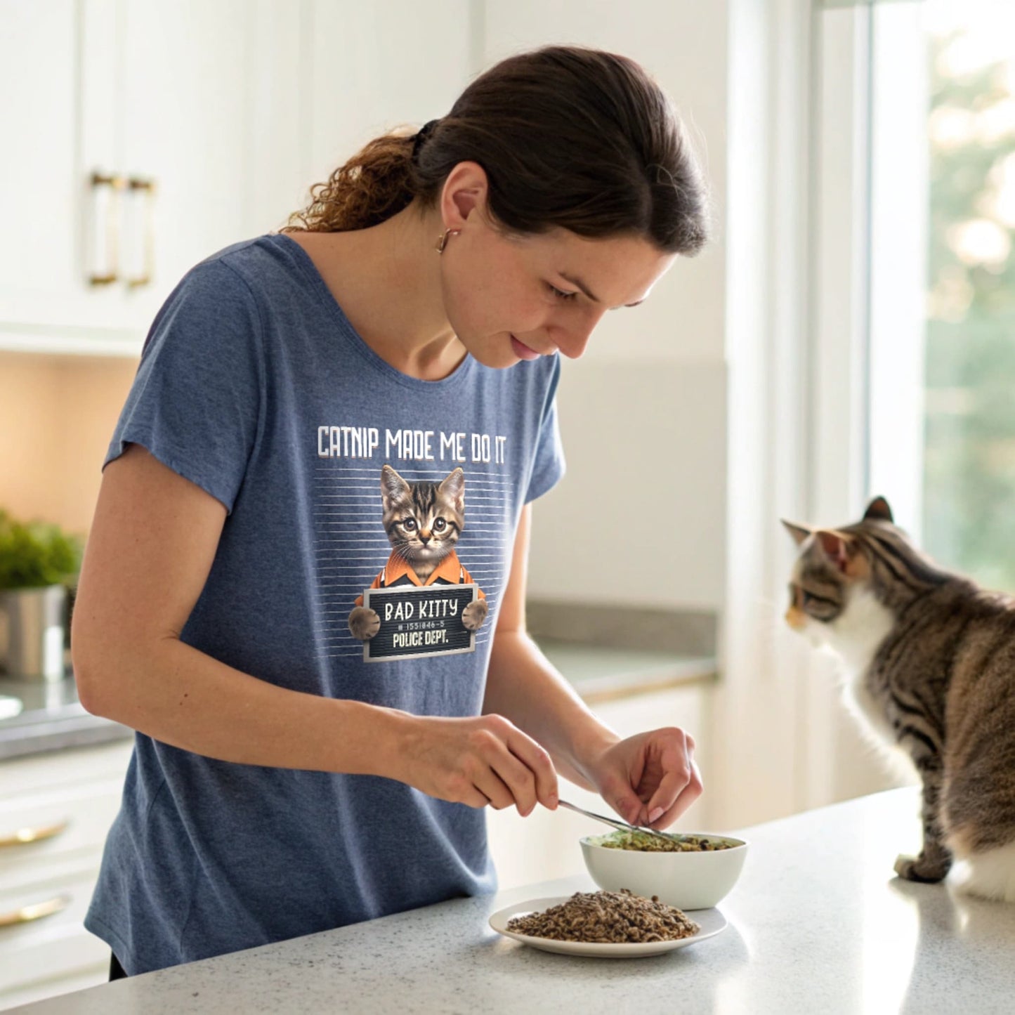 Heather Royal lifestyle mockup of Catnip Made Me Do It T-Shirt on a female model at a kitchen counter, plain crew neck