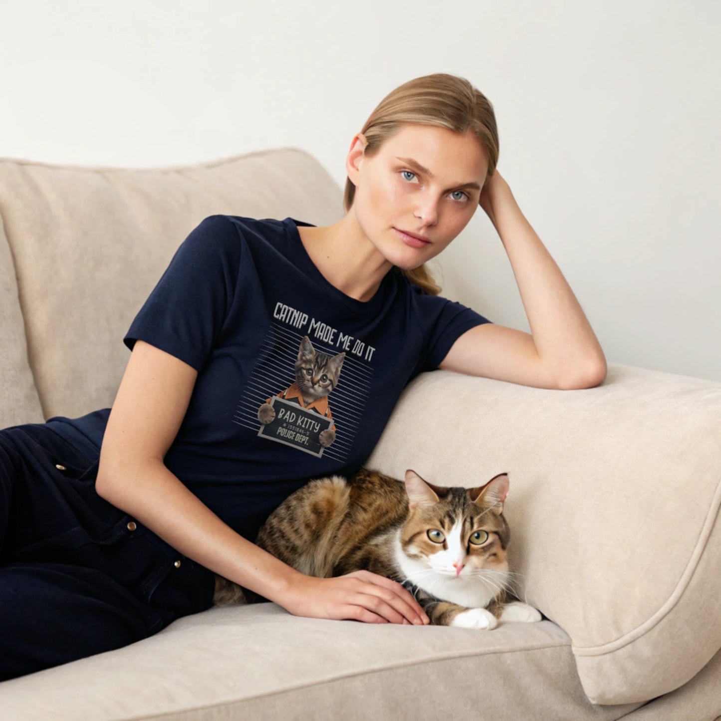 Navy lifestyle mockup of Catnip Made Me Do It T-Shirt on a female model curled up on a couch with a cat, plain crew neck