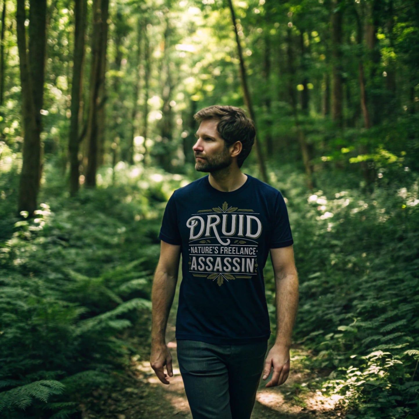 Man wearing navy Druid: Nature’s Freelance Assassin T-Shirt walking through a green forest, relaxed fit crew neck shirt