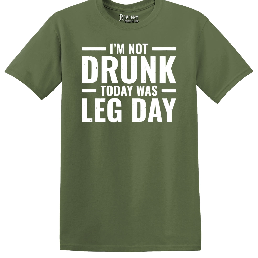 Flat lay of Leg Day Drunk design on military green t-shirt