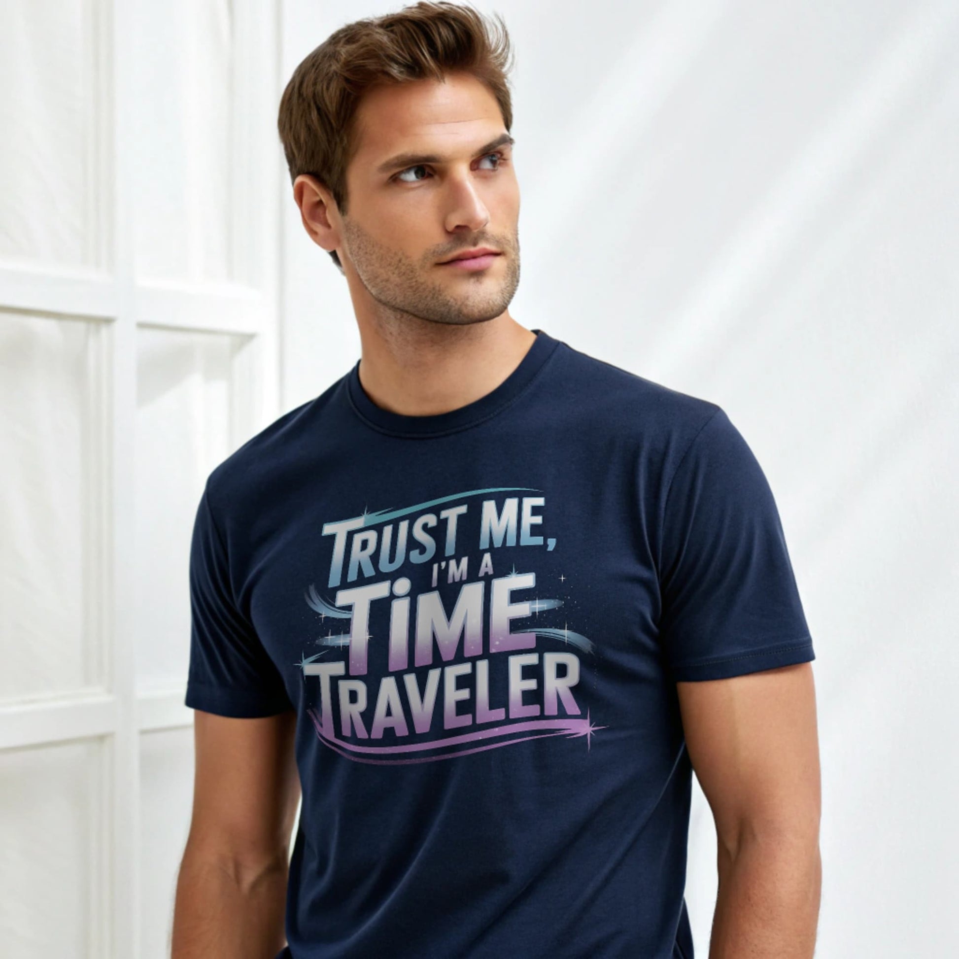 Male model wearing a navy crew-neck t-shirt with “Trust Me, I’m a Time Traveler” graphic, studio shot on white drape background.