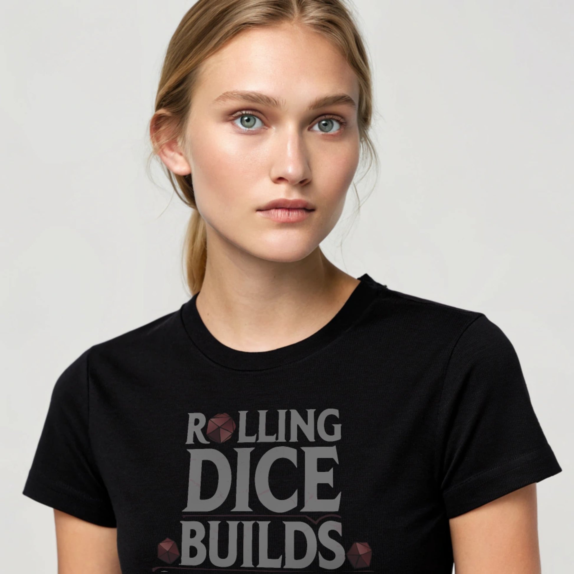 Black studio mockup of Rolling Dice Builds Character tee on a female model, front view, natural eyes, plain crew neck