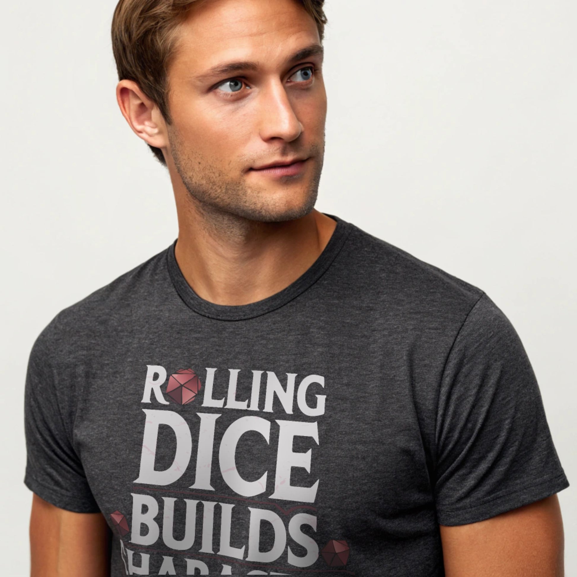 Dark Heather studio mockup of Rolling Dice Builds Character tee on a male model, front view, natural eyes, plain crew neck