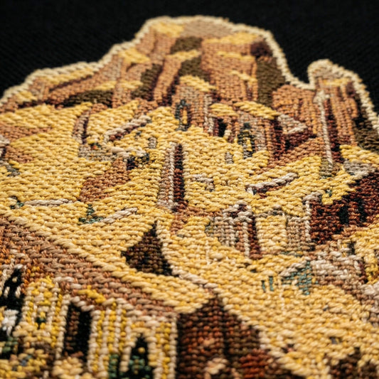 Close-up of the woven texture and stitched detail in the Sunken Sanctum tapestry throw blanket