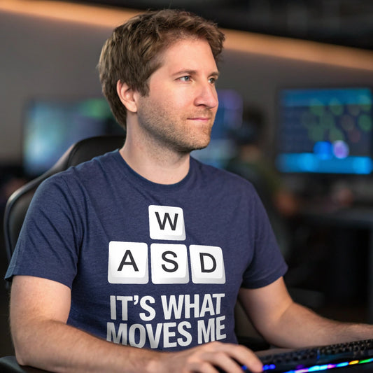 Hyper-realistic mockup of a 25–40-year-old man wearing a WASD Moves T-Shirt at a gaming desk with RGB keyboard and multiple monitors.