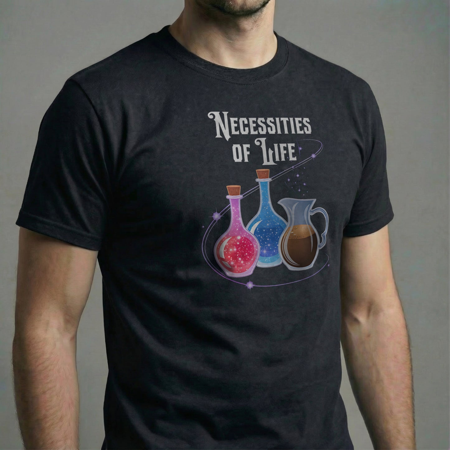 Man wearing a black Necessities of Life T-shirt in a studio close-up