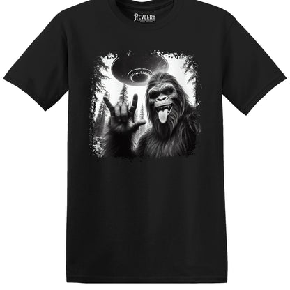 Flat lay of Bigfoot UFO Rocker design on black t-shirt