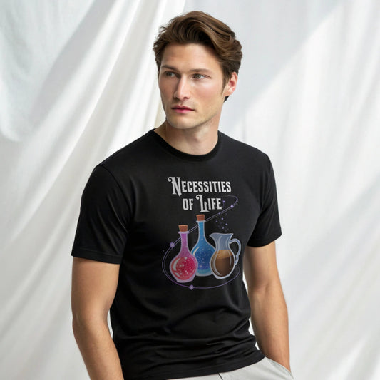 Male model in a black crew-neck t-shirt with “Necessities of Life” potion graphic, studio shot on white drape background.