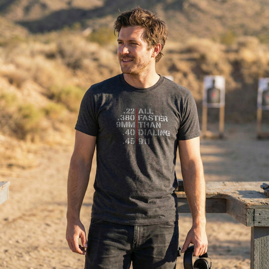 Man wearing Faster Than Dialing 911 T-shirt at an outdoor gun range