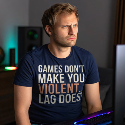 Man in navy gamer shirt staring at screen mid-match, showing “Games Don’t Make You Violent… Lag Does” design