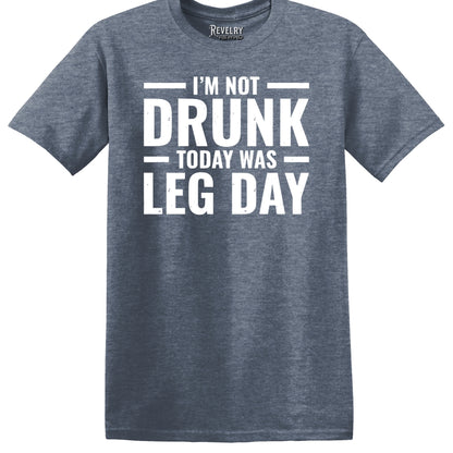 Flat lay of Leg Day Drunk design on heather indigo t-shirt