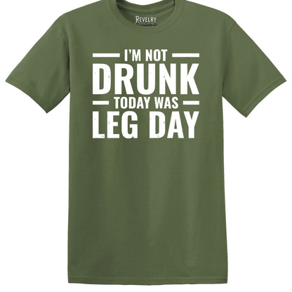 Flat lay of Leg Day Drunk design on military green t-shirt