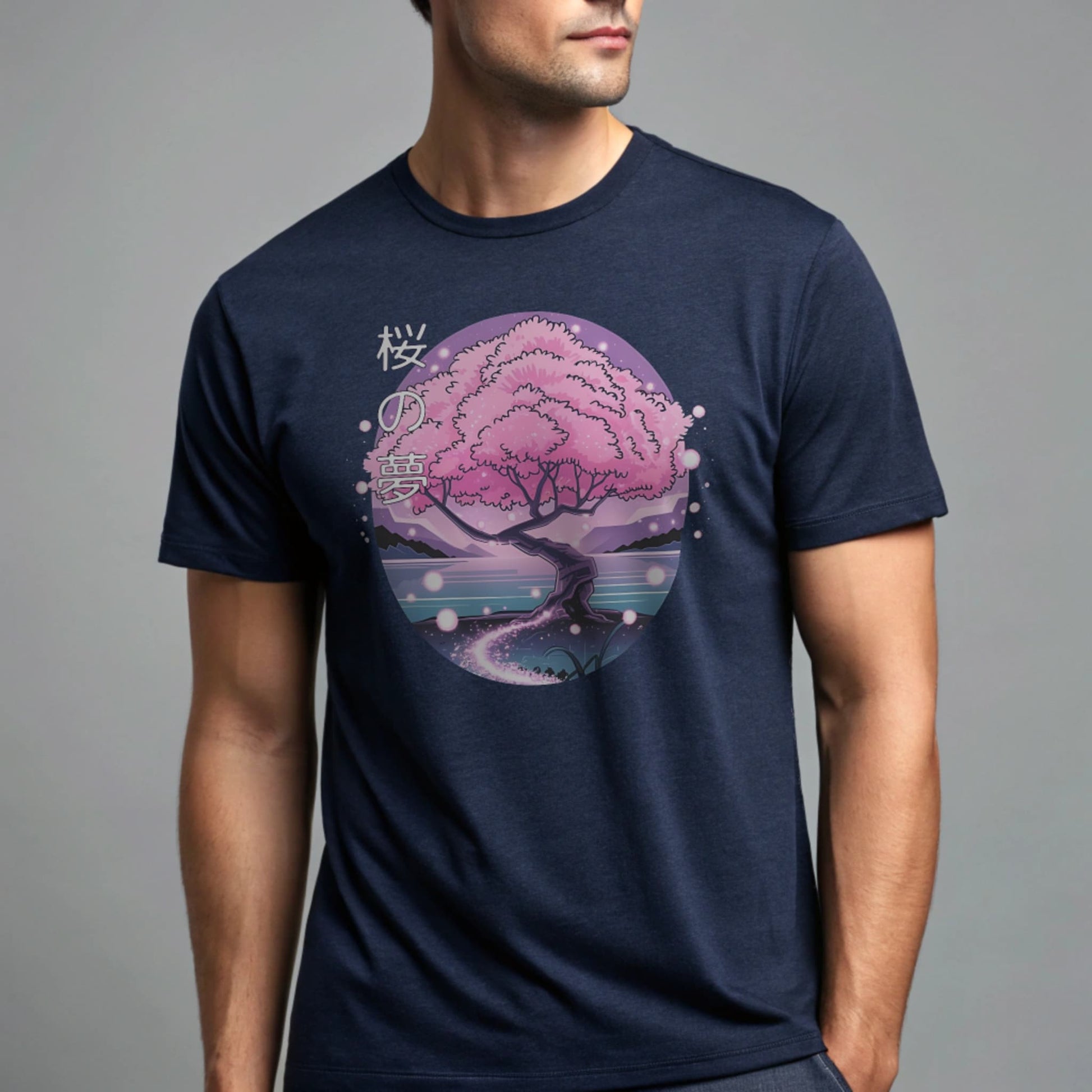 Male model wearing a navy crew-neck t-shirt with pink cherry-tree graphic, studio portrait on a neutral gray background.