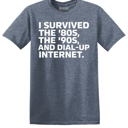 Flat lay of heather indigo t-shirt that says “I Survived the ‘80s, ‘90s…”