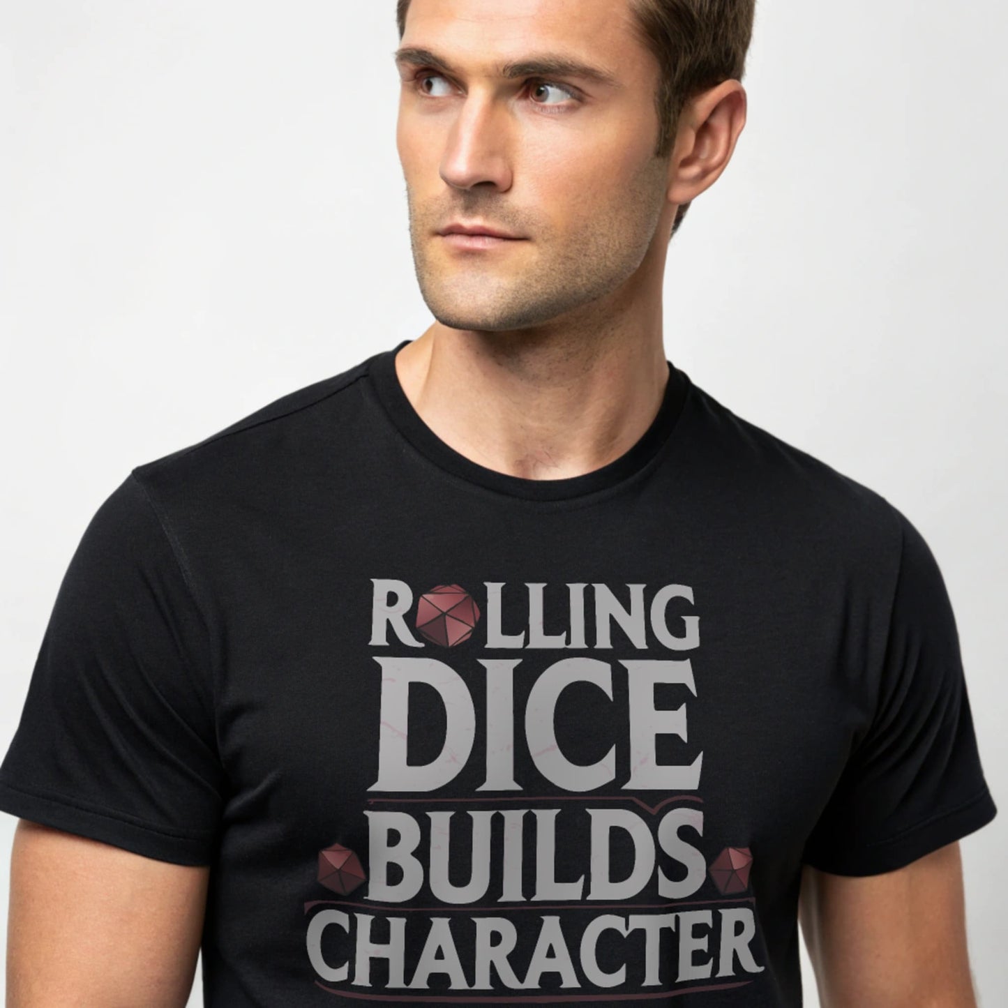 Black studio mockup of Rolling Dice Builds Character tee on a male model, front view, natural eyes, plain crew neck