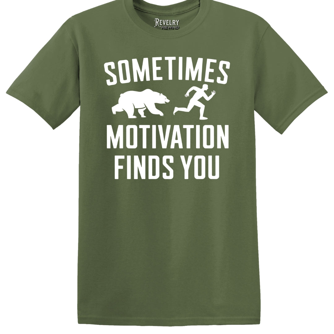 Flat lay of Sometimes Motivation Finds You design on military green t-shirt