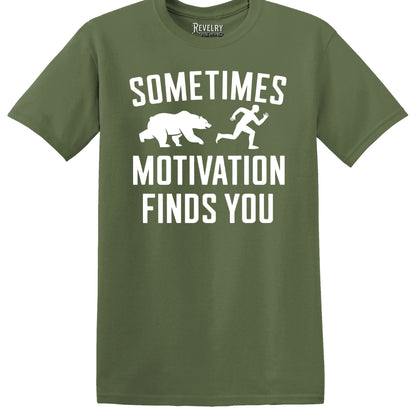 Flat lay of Sometimes Motivation Finds You design on military green t-shirt