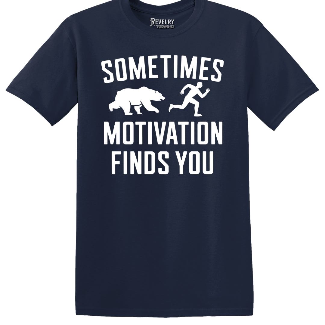 Flat lay of Sometimes Motivation Finds You design on navy t-shirt