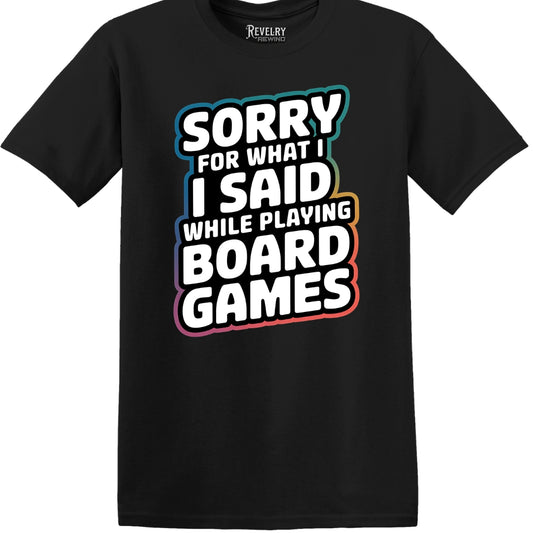 Flat lay of Sorry for What I Said While Playing Board Games design on black t-shirt