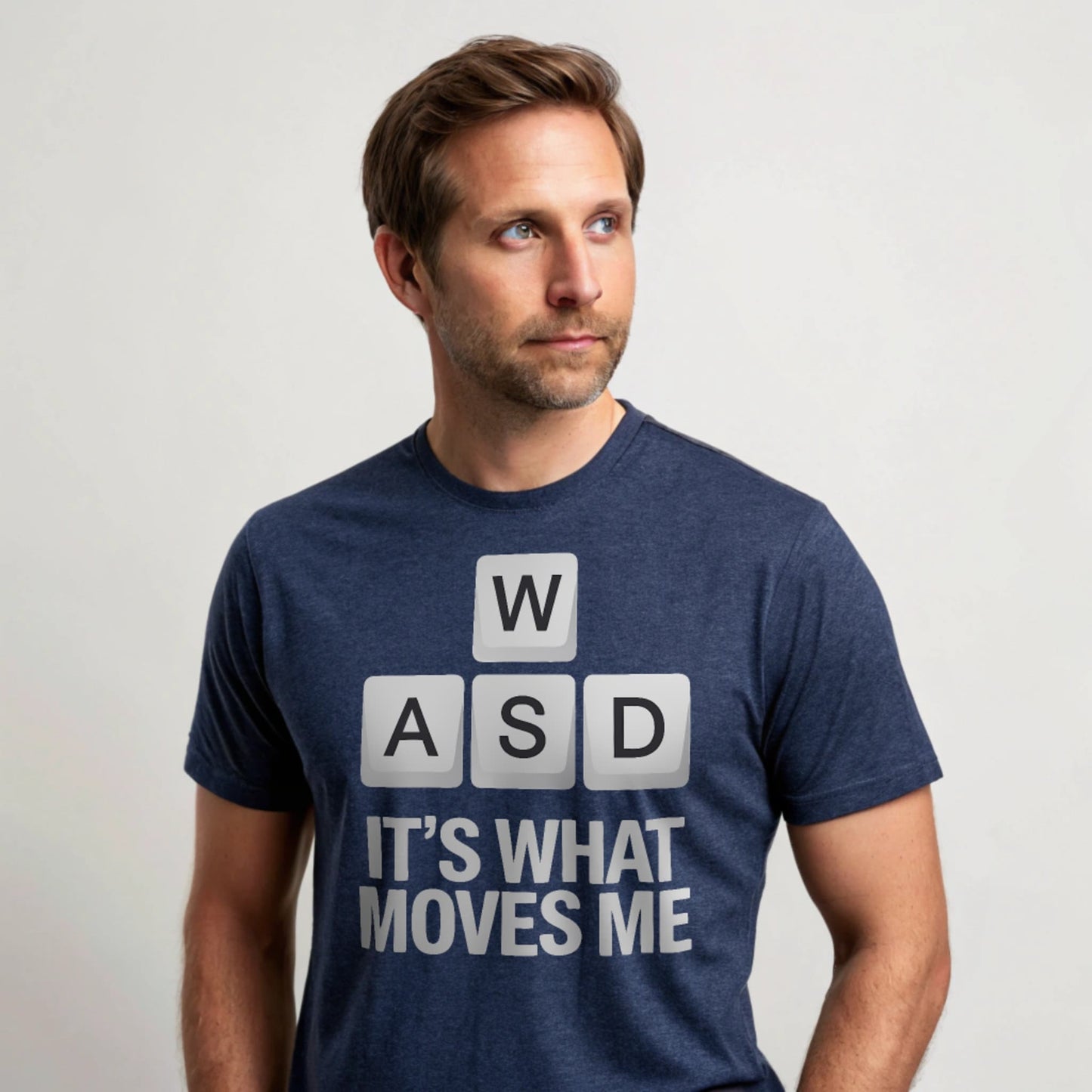 Hyper-realistic mockup of a 25–40-year-old man wearing a plain Gildan 64000 heather navy crew-neck t-shirt with the WASD Moves design, standing face-on against a white background.